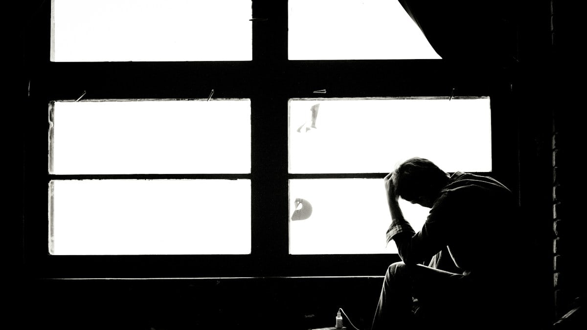 man and woman kissing in grayscale photography